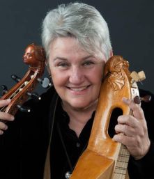 Photo of Mary Springfels with stringed instruments